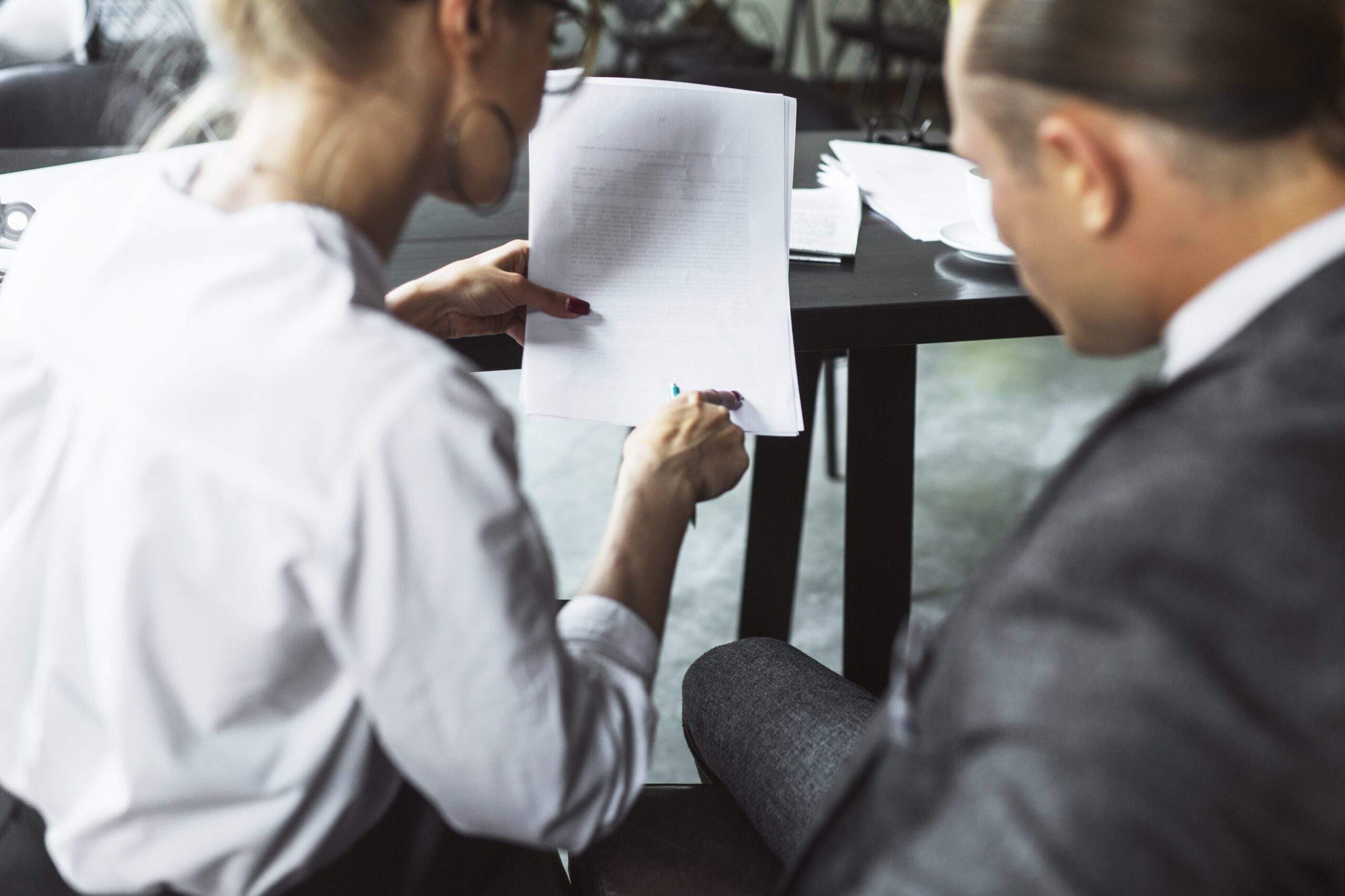 Two business professionals reviewing printed documents, representing transfer pricing documentation requirements.